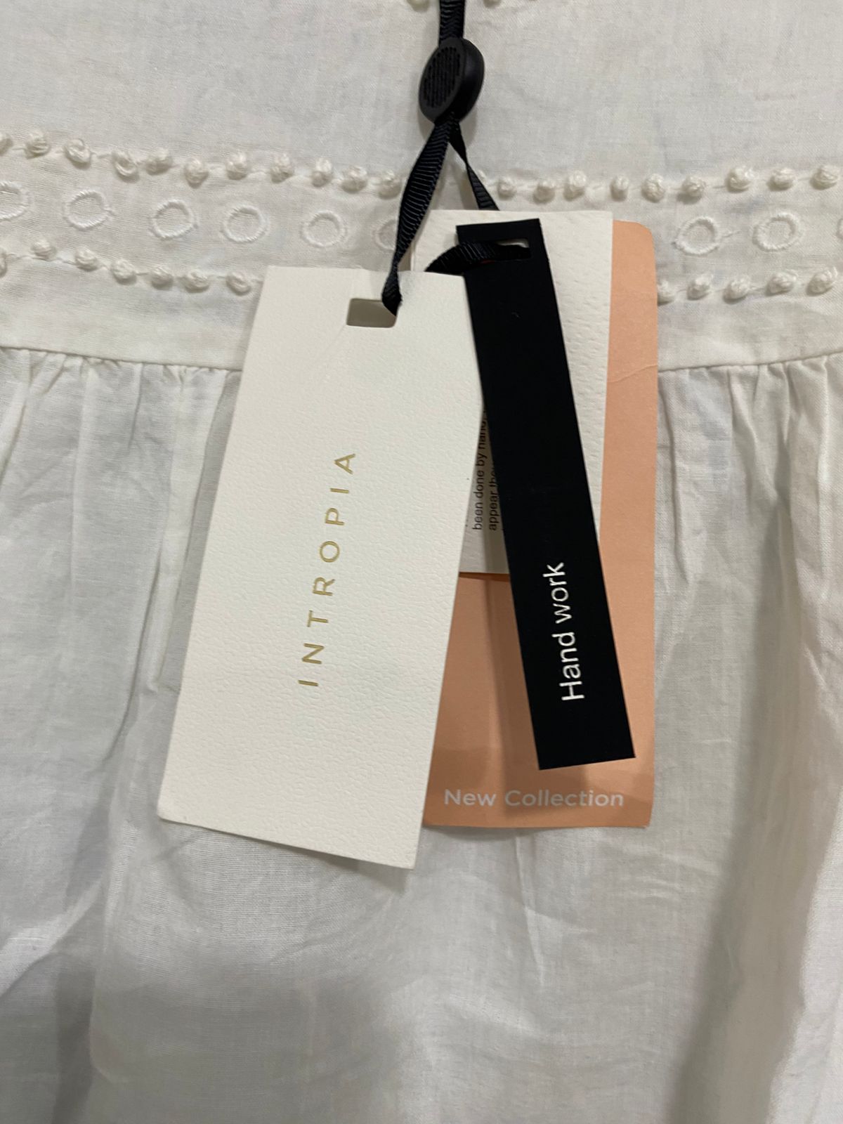 INTROPIA |M| BUST 19| A33| WHITE EYELET EMBROIDERED POM-POM RUFFLE-SHOULDER BLOUSE